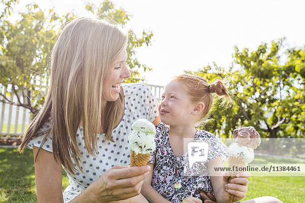 Caucasian mother and daughter eating ice cream cones