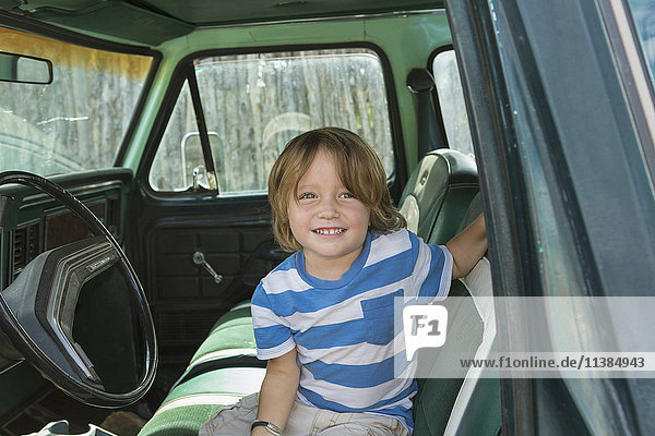 Caucasian boy sitting in truck