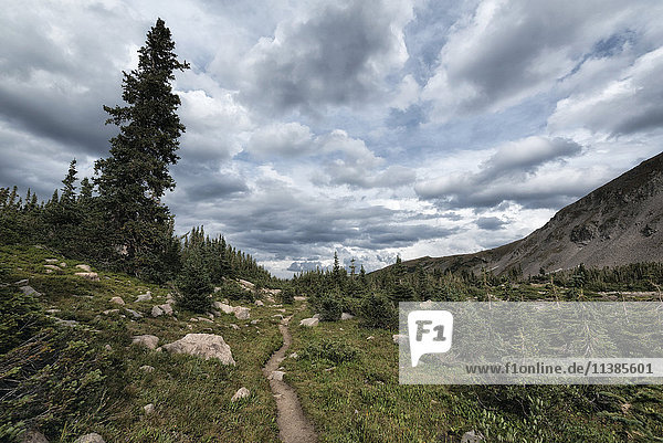 Clouds over trail in rocky landscape