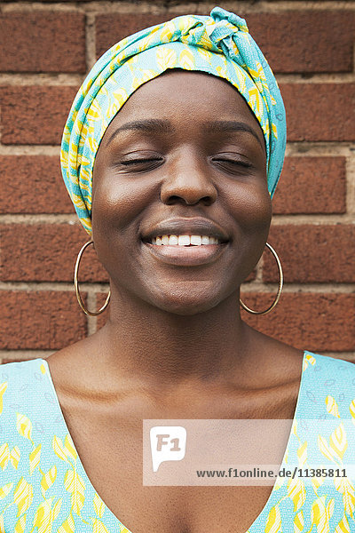Portrait of smiling Black woman with eyes closed