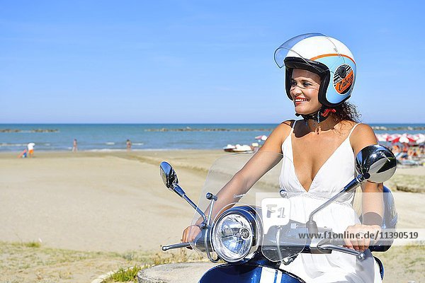 Woman on Vespa scooter  beach  Senigallia  Province of Ancona  Marche  Italy  Europe