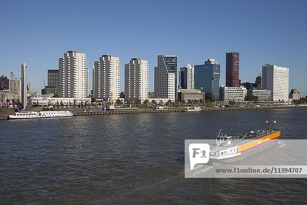Skyline with skyscrapers on Boompjeskai  cargo ship on the Nieuwe Maas River  Rotterdam  Holland  Netherlands