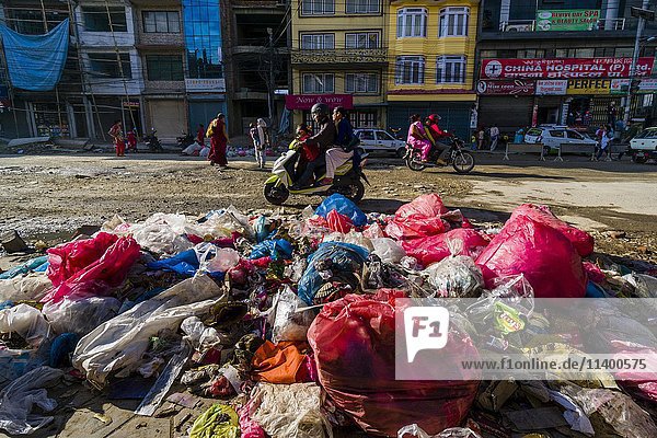 Aufgetürmter Müll neben einer belebten Straße im Vorort Bouda  Kathmandu  Nepal  Asien