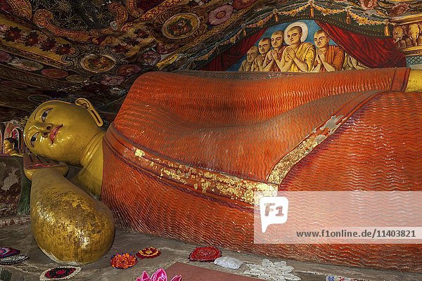 Reclining Buddha statue and painted ceilings  Aluvihara Rock Cave Temple  Central Province  Sri Lanka  Asia