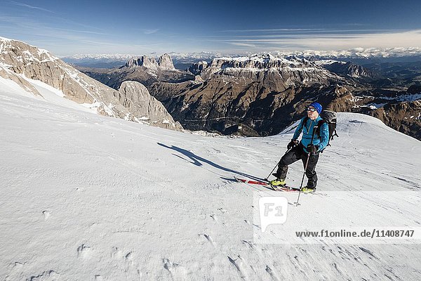 Ski mountaineer in ascent to Punta Rocca  behind Sellastock  Langkofel and Plattkofel  snowy Alps  Fassa Valley  Dolomites  South Tyrol  Italy  Europe