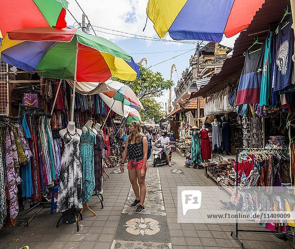 Touristin betrachtet Kleider  Traditioneller Kunstmarkt  Ubud  Bali  Indonesien  Asien