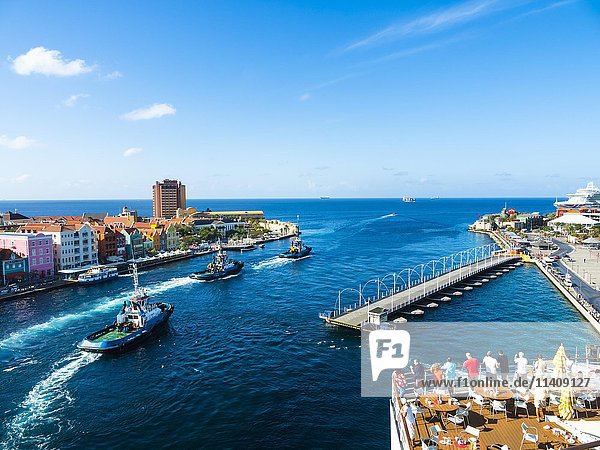 Tugboat  colorful row of houses in Punda district at back  commercial arcade  waterfront  World Heritage Site  Willemstad  Lesser Antilles  Curacao  North America