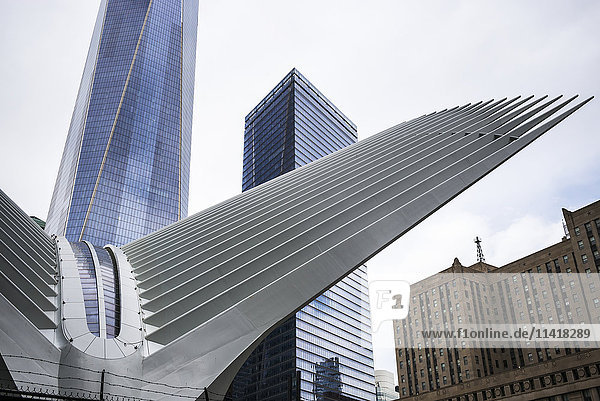 'Modern structure with white prongs like wings  skyscraper and One World Trade Center; New York City  New York  United States of America'
