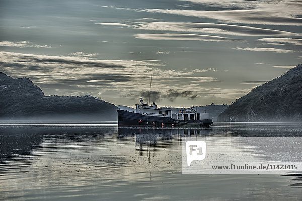 Fishing vessel in Geographic Harbor at sunrise,  Southwest Alaska,  USA
