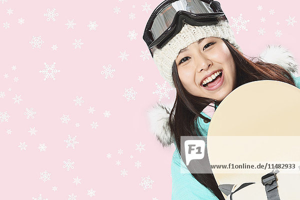 Young Japanese woman snowboarding