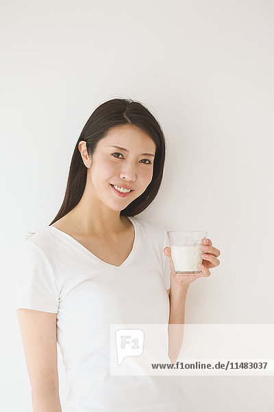 Portrait of young Japanese woman in a white room