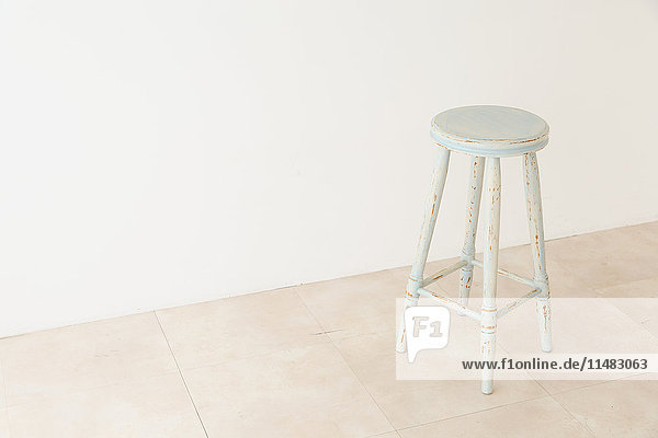 Wooden chair in a white room