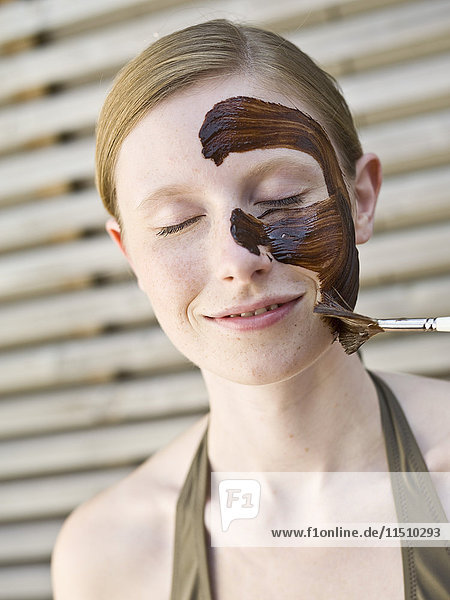 Young woman with face pack