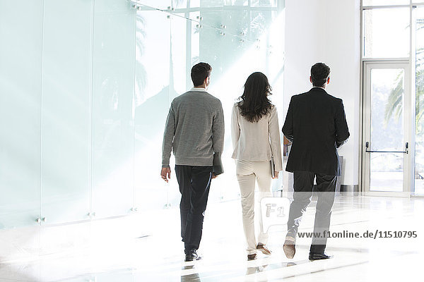 Business associates walking together in office