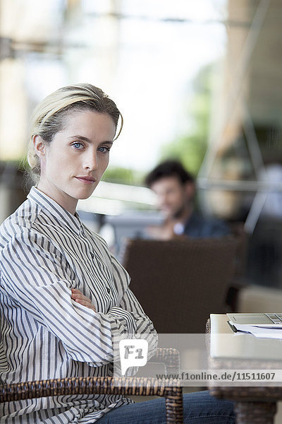 Woman with arms folded and determined look on face  portrait