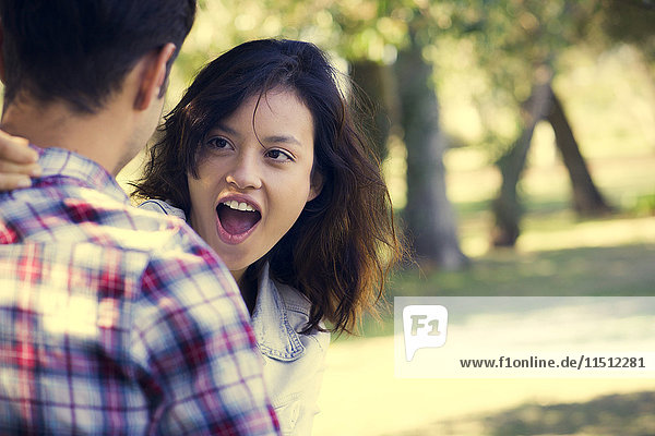 Young woman making face at boyfriend