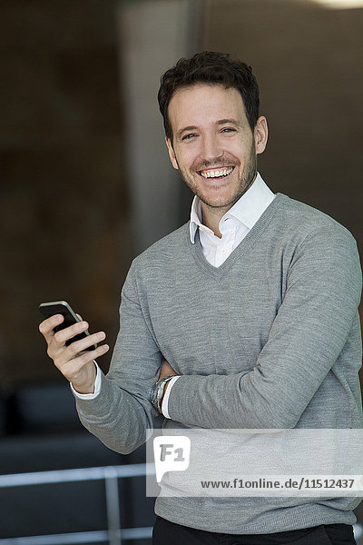 Businessman relaxing with smartphone