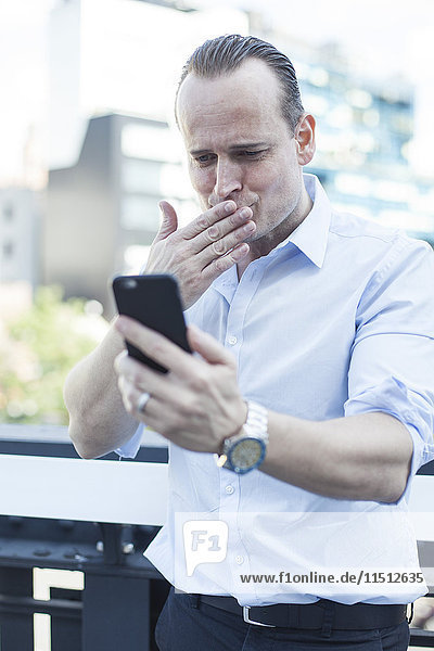 Man blowing a kiss at smartphone