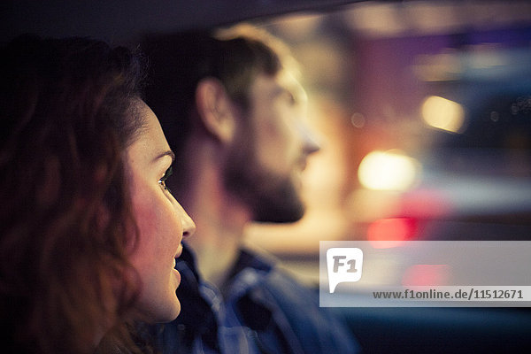 Paar schaut nachts aus dem Autofenster