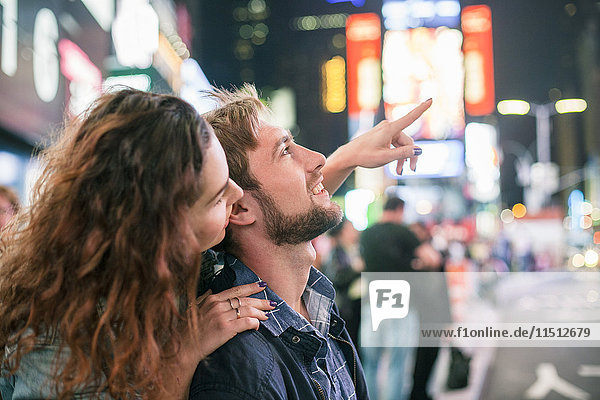 Young couple sightseeing in Times Square,  New York City,  New York,  USA