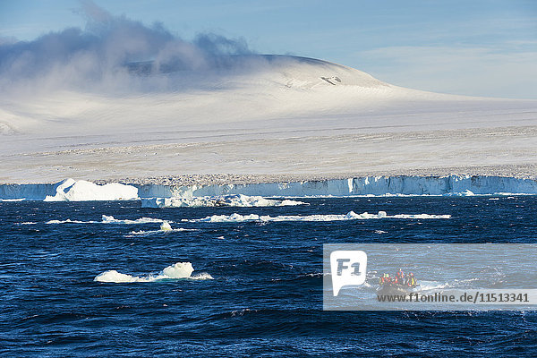 Zodiac with tourists cruising through the icebergs  Brown Bluff  Tabarin Peninsula  Antarctica  Polar Regions