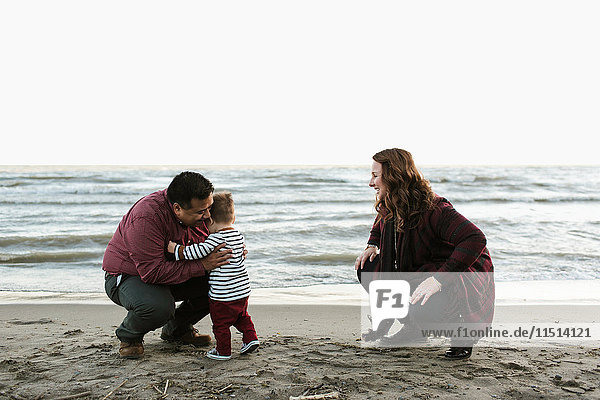 Family with baby boy on beach