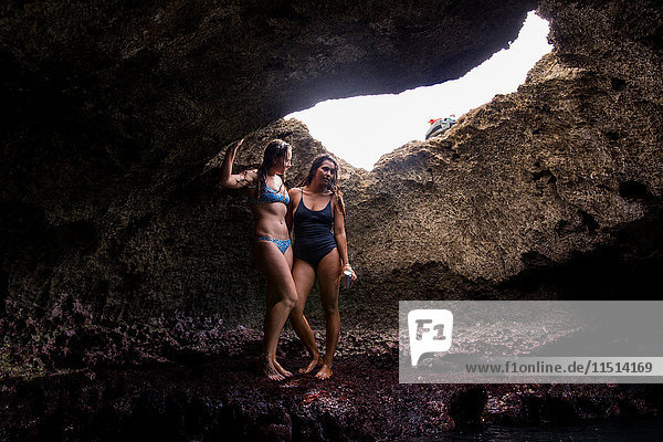 Friends in cave wearing swimwear  Oahu  Hawaii  USA