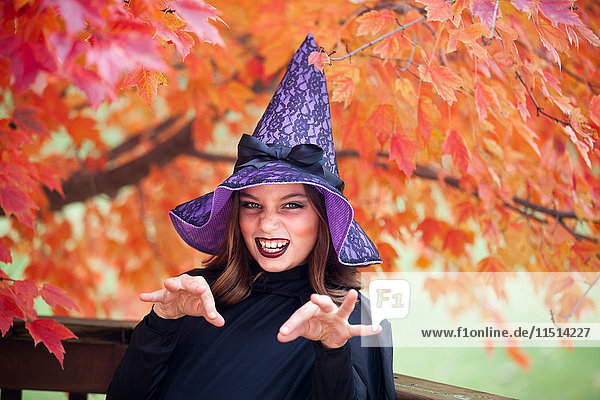 Girl making face dressed as witch for Halloween