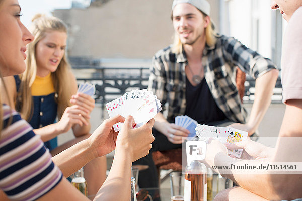 Young adults playing card game at roof terrace party  Budapest  Hungary