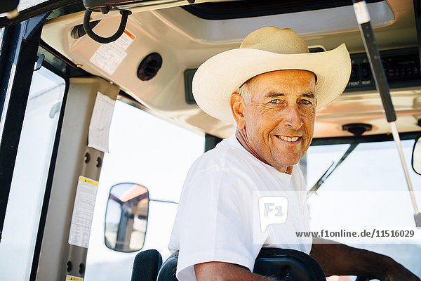 Portrait of smiling Caucasian farmer in tractor