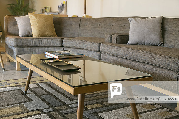 Coffee table with glass and sectional sofa