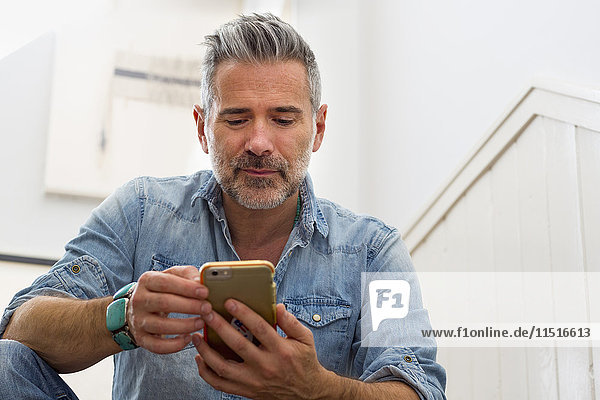 Caucasian man texting on cell phone