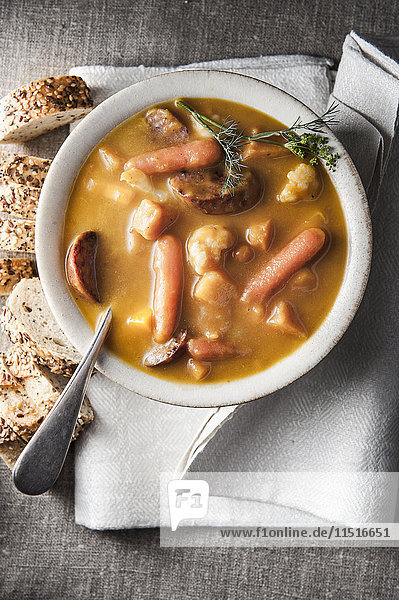 Bowl of stew with bread and napkin