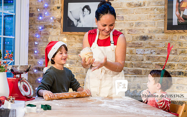 Mother and son making Christmas cookies at home