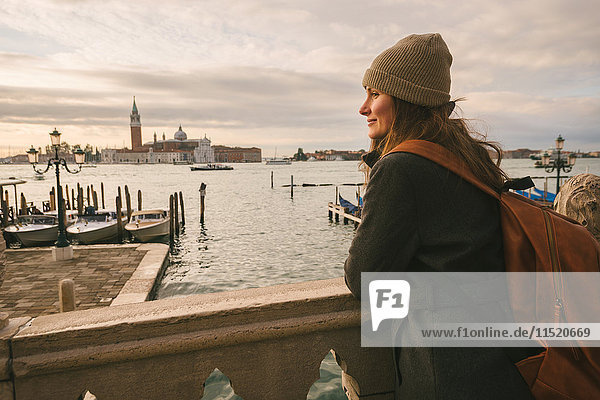 Woman on bridge in Grand Canal  San Giorgio Maggiore Island in background  Venice  Italy