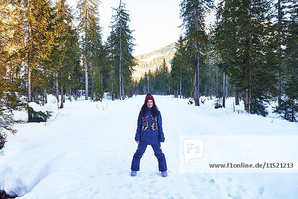 Portrait of woman in knit hat and winter clothes in snowy forest  Austria