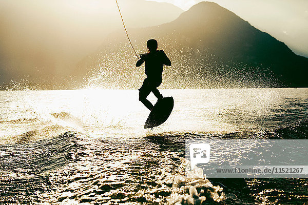 Silhouette of waterskier waterskiing  Maggiore lake  Verbania  Piedmont  Italy