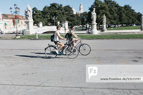 Italy  Padua  two young tourists riding bicycle
