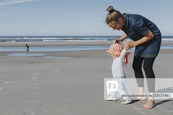 Netherlands  Schiermonnikoog  mother walking with little daughter on the beach