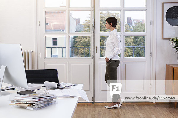 Woman standing at the window in office