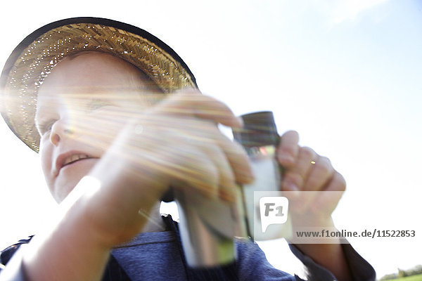 Boy with binoculars outdoors