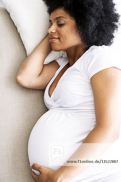 Pregnant woman relaxing on couch