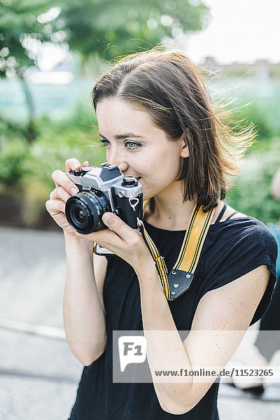 Woman taking pictures with camera