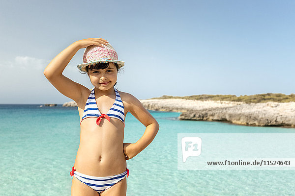 Girl standing at the beach  smiling at camera