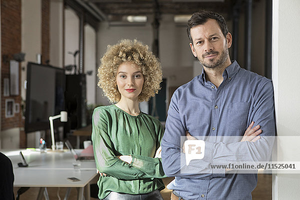 Portrait of confident man and woman in office