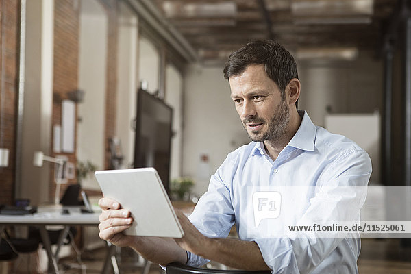 Businessman using tablet in office