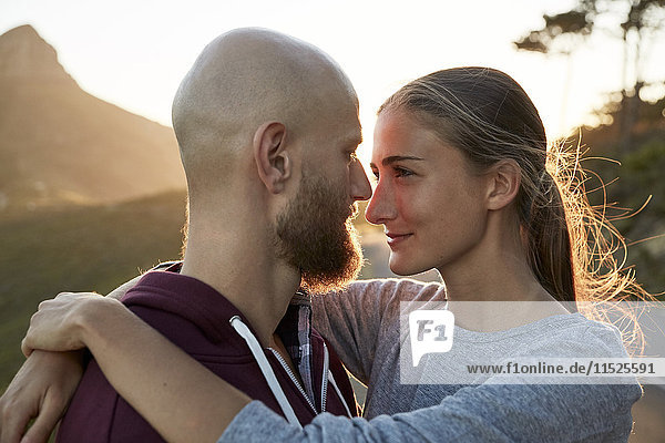 Young couple in love face to face at backlight