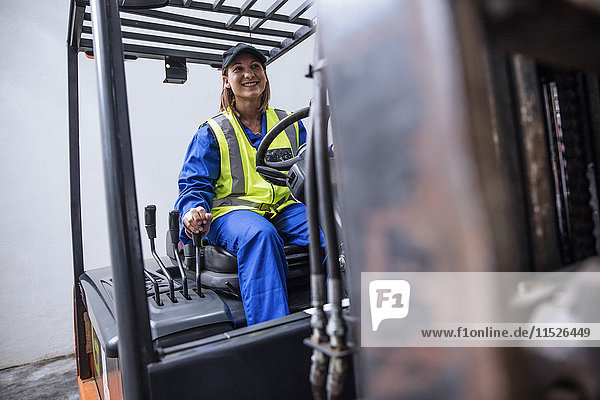 Smiling woman on forklift