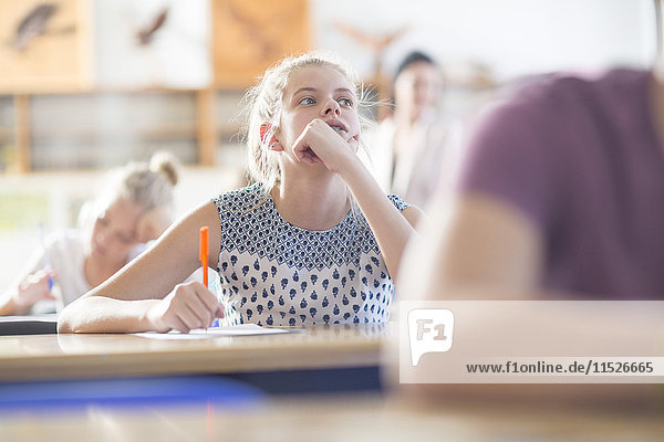 Female student in thought in class