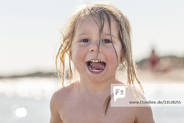 Portrait of smiling girl by sea